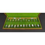 Collection of silver and white metal souvenir spoons, with enamelled decoration, within an