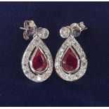 Pair of attractive ruby and diamond pear shaped drop earrings in 18ct white gold, round brilliant-