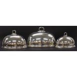 Three silver plated food covers, each with naturalistic scrolled handle and beaded base, the largest