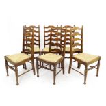 Set of six oak ladder back dining chairs with rush seats and turned supports united by stretchers