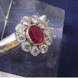 18ct ruby and diamond oval cluster ring, the central ruby in a surround of ten round brilliant-cut