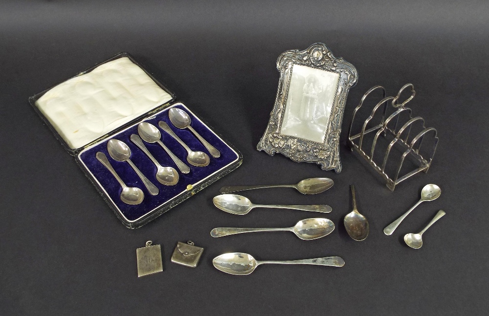 Assorted silver items to include a four section lancet toast rack, embossed Art Nouveau silver