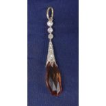 Attractive platinum and gold drop pendant, with a facet-cut pear shaped topaz and old-cut diamond