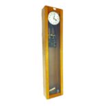 Electric master clock, the 6.5" silvered dial within a glazed light oak case, 50" high (pendulum)