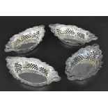 Set of four late Victorian silver oval trinket dishes, repousse with scrolling foliage and with