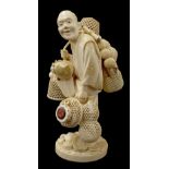 Fine Japanese ivory okimono signed Saizan, finely carved and modelled as a standing gentleman