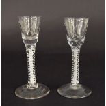Pair of 18th century cordial glasses, each with engraved tapered bowls, white opaque air twist and