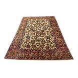 Good Persian silk rug, worked with exotic birds and animals amidst foliage upon a cream ground