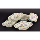 Set of four Chinese famille rose lobed porcelain dishes and a similar larger dish, decorated with