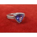 18ct tanzanite and diamond ring, the trilliant-cut tanzanite 2.12ct approx, in a surround of