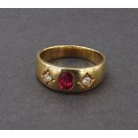 (133254-1-A) Ruby and diamond three stone gypsy yellow gold ring, the oval ruby flanked by two round