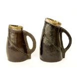 Matched pair of Doulton Lambeth stoneware jugs in the form of leather jacks, each with silver