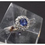 18ct sapphire and diamond cluster ring, the sapphire 1.25ct approx, ring size O