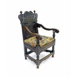 Antique oak Wainscot type armchair, the blind fret carved panelled back with a Tudor rose over a