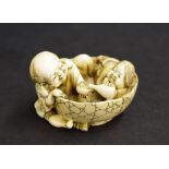 Japanese ivory netsuke, modelled with a lady and gentleman in a circular tub sharing a drink,