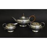 Silver three piece bachelor tea service of squat form decorated with a reeded band, maker William