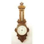 Light oak two glass barometer, the 8" dial within a carved oak case