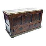 18th century oak mule chest, the hinged top over the triple panelled front and two short drawers,