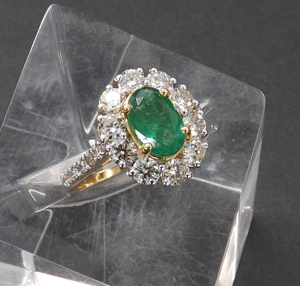 Impressive 18ct yellow gold emerald and diamond oval cluster ring, the central emerald (8mm x 5mm)