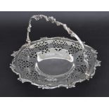 Attractive Victorian silver circular cake basket, with a cast foliate swing handle and similar