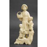 Japanese ivory okimono modelled with a mother holding a basket with her two children by her side