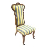 Attractive Victorian walnut upholstered nursing chair, the shaped back with carved flowerheads