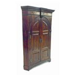 Georgian oak standing corner cupboard, with arched fielded panel doors enclosing a green painted