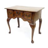 George III oak lowboy, with three drawers over the shaped frieze upon cabriole legs terminating with