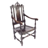 Antique oak Wainscot style hall armchair, the raised back with a carved blind fret central panel