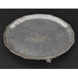 Circular silver salver with a rope twist border and three scroll feet, maker Adie Brothers