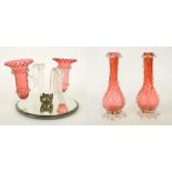 Victorian cranberry glass epergne with two spill vases and moulded leaf branches upon a circular