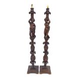 Pair of decorative antique carved standard lamps, possibly Italian, each modelled with standing