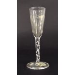 Antique drinking glass, the tapered conical bowl engraved with flowers upon an opaque air-twist