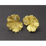 Pair of 18ct Andrew Grima leaf shaped earrings, each set with a single small round diamond and