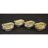 Set of four late Victorian silver boat shaped half fluted salts, with gilded interiors, maker