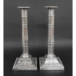 Good matched pair of George III silver candlesticks, each with detachable sconces, sheathed