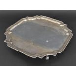 Mappin & Webb silver salver of square form with cut corners upon four scroll feet, Sheffield 1945,