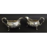 Pair of George III silver sauce boats, with gadrooned rims and repousse with flowers and foliage,