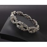 Attractive platinum and diamond set bracelet, with eight pierced foliate oval links, 32.3gm, 7"