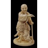 Japanese ivory okimono signed Ikkansai, carved and modelled as an elderly figure using a stick