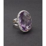Fiorelli 18ct white gold large cocktail ring, the oval facet cut amethyst within a surround of round