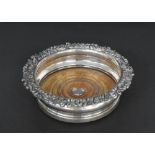 George III silver wine coaster with a cast foliate rim and wooden inset base with a silver