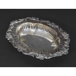 Late Victorian oval silver pierced trinket dish with floral scroll border, maker William Hutton &