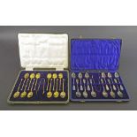 Cased set of twelve silver-gilt teaspoons and tongs, Sheffield 1922; together with another cased set