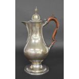 George III silver ewer, of baluster form with a hinged cover surmounted with an urn finial, scroll