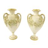 Pair of late 19th century bisque porcelain twin handled vases in the manner of Worcester, with