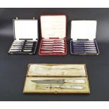 Cased set of six silver handled butter knives with pistol handles; also two other sets of cased