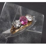 18ct ruby and diamond three stone ring, the ruby 0.47ct flanked by two round old European-cut