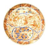 Large Japanese porcelain charger, decorated in Imari palette with traditional landscapes, Buddhistic