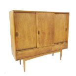 Austin Suite teak sideboard, with three sliding doors over two drawers and tapered legs, 53.5" wide,